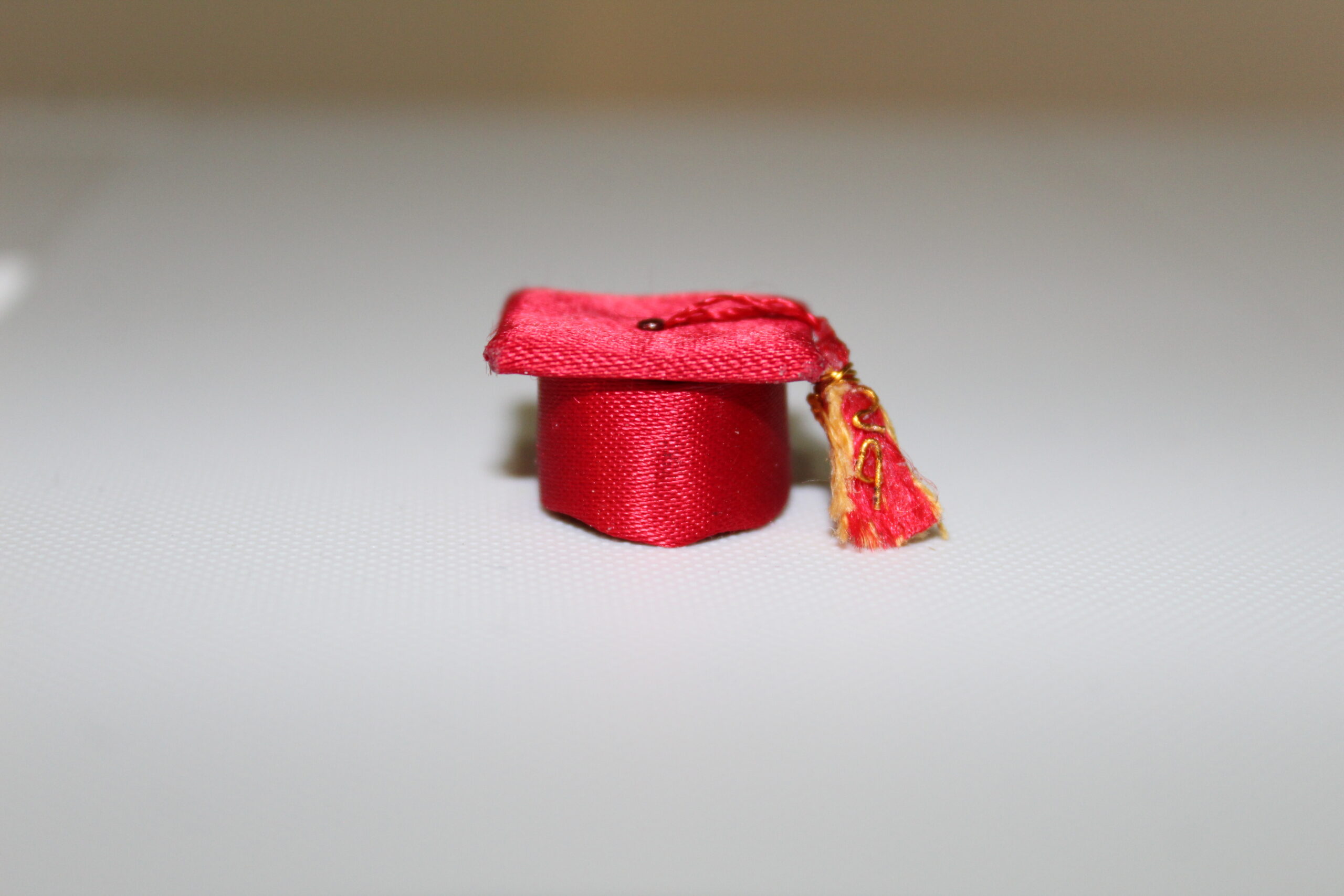 Make a satin graduation hat with two-color tassel.