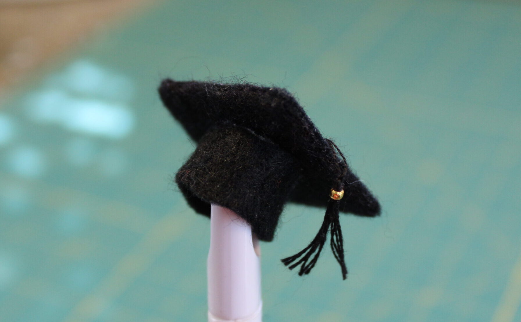 Make a traditional black graduation cap.